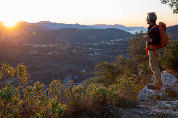 istock Hiker relaxes on mountain ridge at sunrise 1286866343