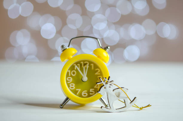 istock Yellow alarm clock on the table. Bokeh. 1286867149