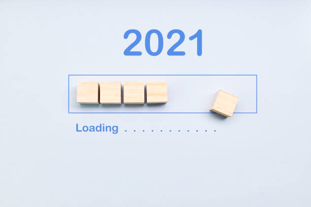 istock Loading 2021 year on wooden cubes on a blue background. Downloading new year 2021 1286867576