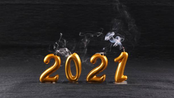 istock extinguished golden New Year 2021 candles on black background. modern concept 1286868926