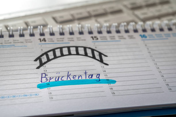 Calendar on a computer keyboard with the word Bridging day in German as a symbol for vacation planning