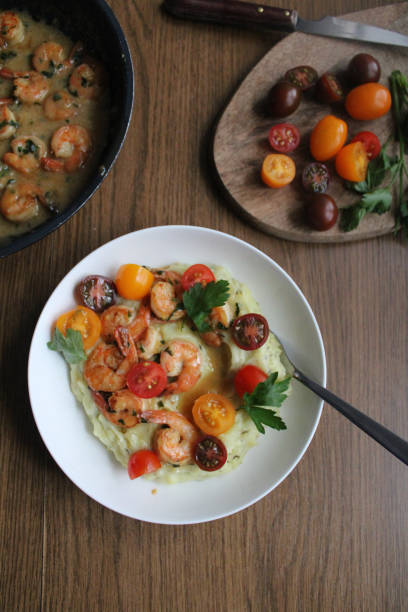 istock Glazed garlic shrimp over mashed potatoes and topped with cherry tomatoes. 1286870328