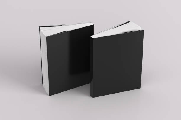istock Two softcover or paperback vertical black mockup books standing on the white background. Blank front and back cover. 1286874784