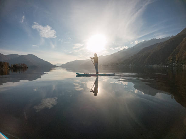 istock Young woman paddling on a paddle board on a lake 1286875851