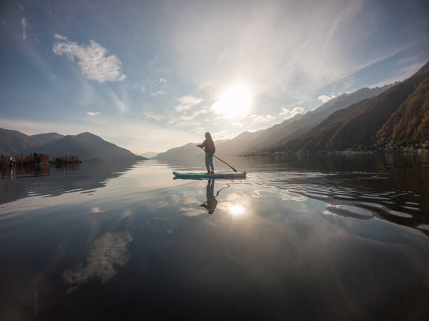 istock Young woman paddling on a paddle board on a lake 1286875913