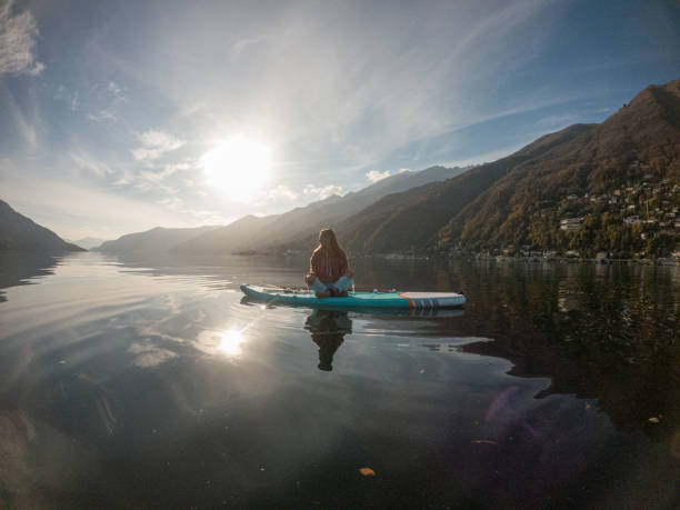 istock Young woman paddling on a paddle board on a lake 1286875946
