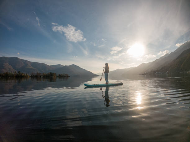 istock Young woman paddling on a paddle board on a lake 1286876024