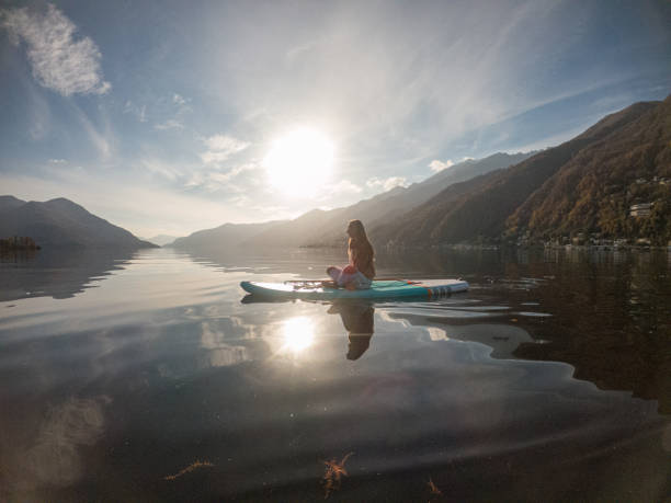 istock Young woman paddling on a paddle board on a lake 1286876068