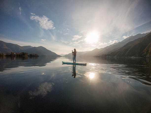 istock Young woman paddling on a paddle board on a lake 1286876101