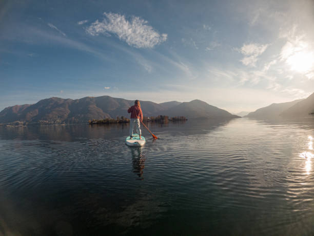 istock Young woman paddling on a paddle board on a lake 1286876134