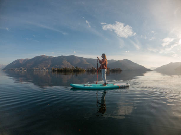 istock Young woman paddling on a paddle board on a lake 1286876203