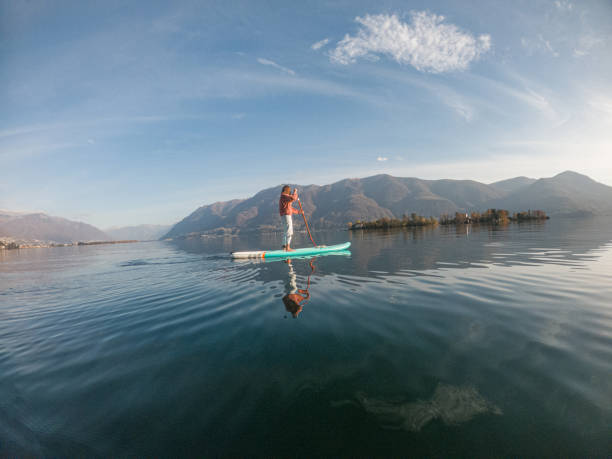istock Young woman paddling on a paddle board on a lake 1286876209