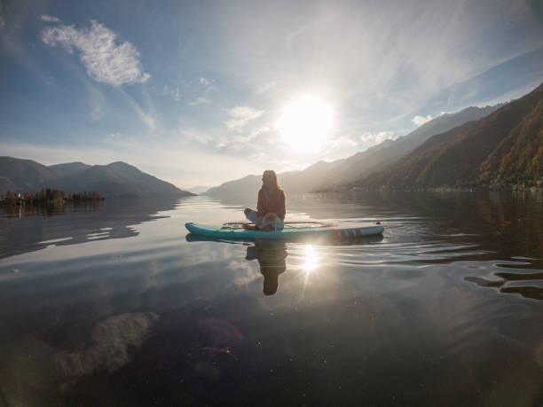 istock Young woman paddling on a paddle board on a lake 1286876240