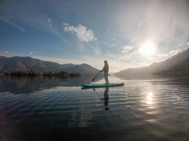 istock Young woman paddling on a paddle board on a lake 1286876820