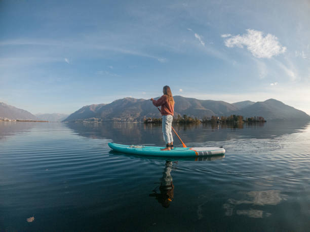 istock Young woman paddling on a paddle board on a lake 1286876955
