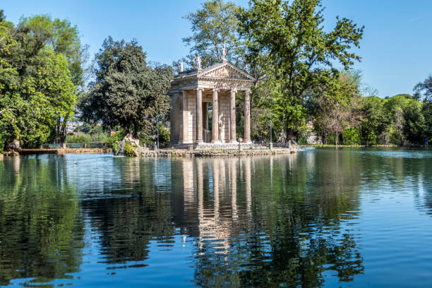 istock Small lake with trees reflecting in the water in Villa Borghese park 1286877266