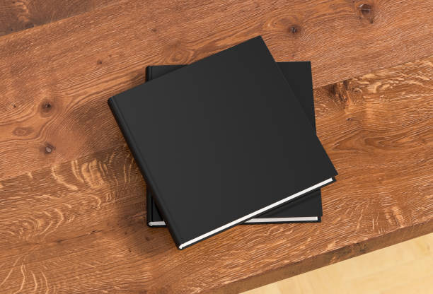 istock Square black hardcover book stack mockup on the wooden table. 1286878410