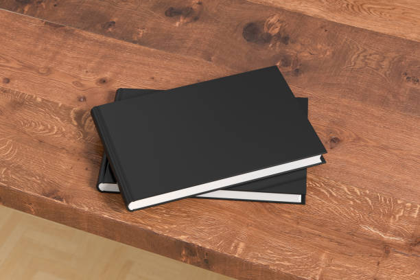 istock Horizontal or landscape black hardcover book stack mockup on the wooden table. 1286878423