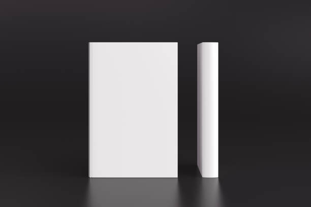 istock Two hardcover vertical white mockup books standing on the black background. Blank front cover and spine of book. 1286878986