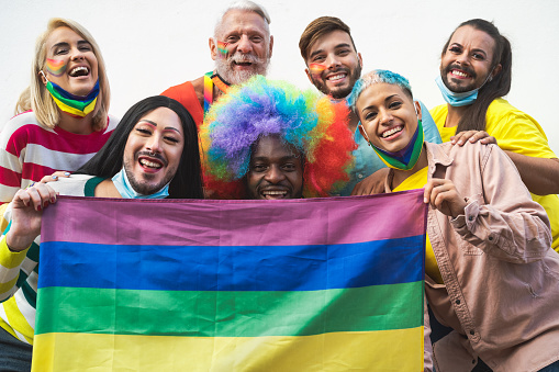 Happy Multiracial people celebrating gay pride festival during corona virus - Group of friends with different age and race fighting for gender equality