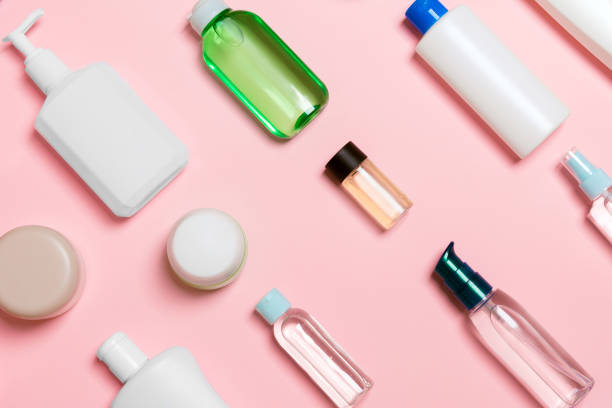istock Top view of different cosmetic bottles and container for cosmetics on pink background. Flat lay composition with copy space 1286883094