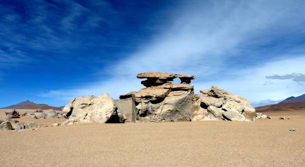 istock Volcanic rock formations and stones in sand vast desert, strange bizzare rocks, cliffs, impressive cloudscape, loneliness, solitude landscape, Bolivia. 1286883746