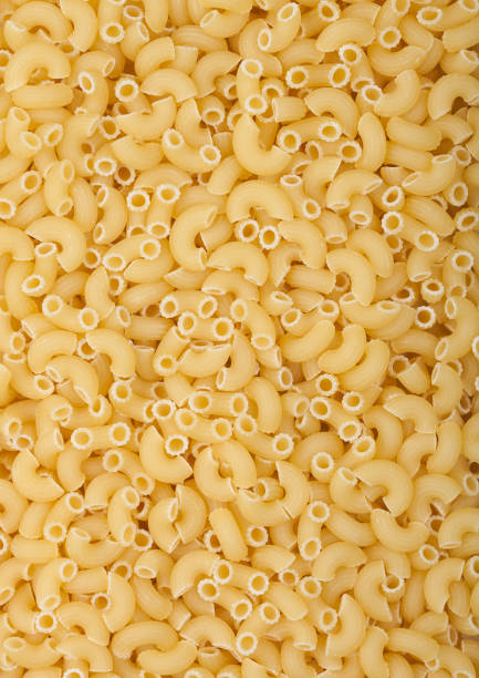 istock Fresh raw classic maccheroni elbows pasta ias texture background. 1286886584
