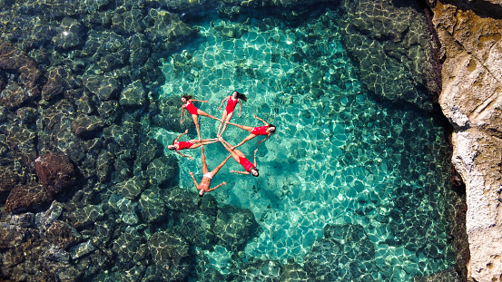 A group of girls doing synchronized swim at a Beach in Mallorca, Balearic Islands durint de summer