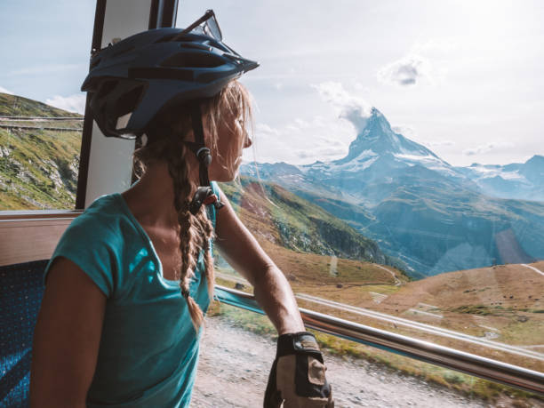istock Mountain biker looks out of sunny train window, Matterhorn view 1286888718