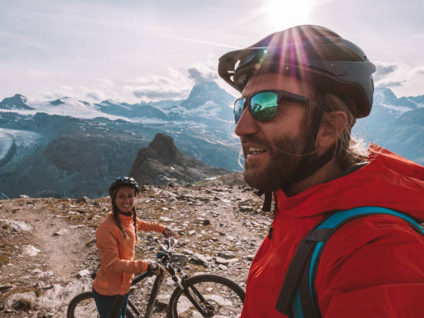 istock Mountain bikers pause on dirt trail to contemplate landscape 1286888721