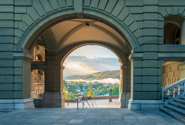 view from the inner courtyard of the federal palace on the bernese urban landscape at sunrise - berne swiss culture parliament building switzerland imagens e fotografias de stock