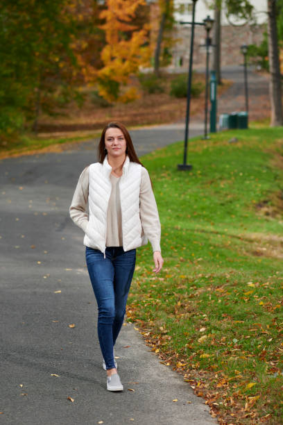 istock Cute young woman among fall foliage on campus 1286889776