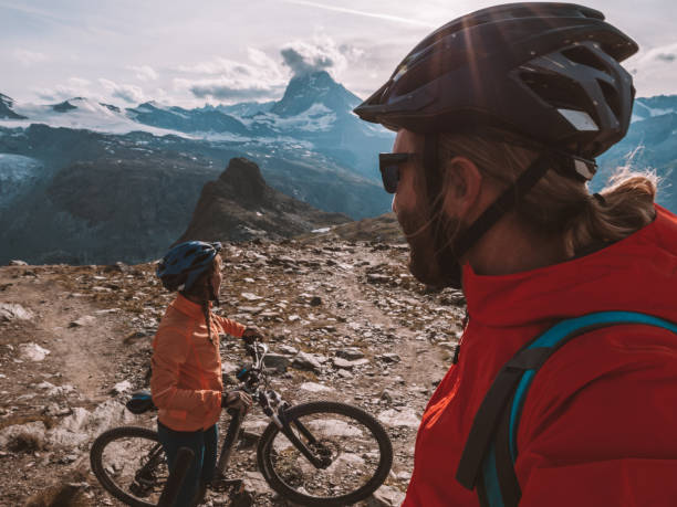 istock Mountain bikers pause on dirt trail to contemplate landscape 1286890974