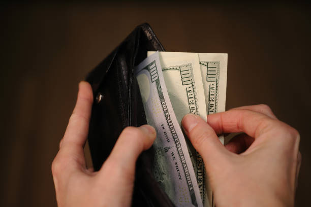 istock wallet with one hundred dollar bills in women's hands 1286893920