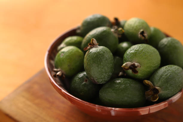 istock feijoa in a bowl on a wooden background. Close. 1286893993