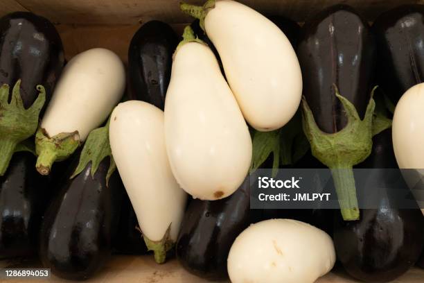White And Black Eggplants On A Market Stall Stock Photo - Download Image Now - White Eggplant, Agriculture, Close-up