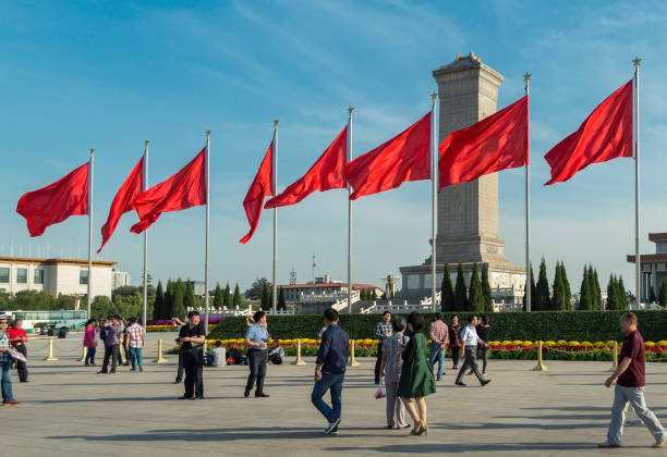 Red banners unfurled in the wind at Tiananmen square in Beijing, China Beijing / China - September 27, 2014: Red banners unfurled in the wind at Tiananmen square ahead of the National Day celebration (65th Anniversary of the Founding of the People's Republic of China). xi jinping stock pictures, royalty-free photos & images