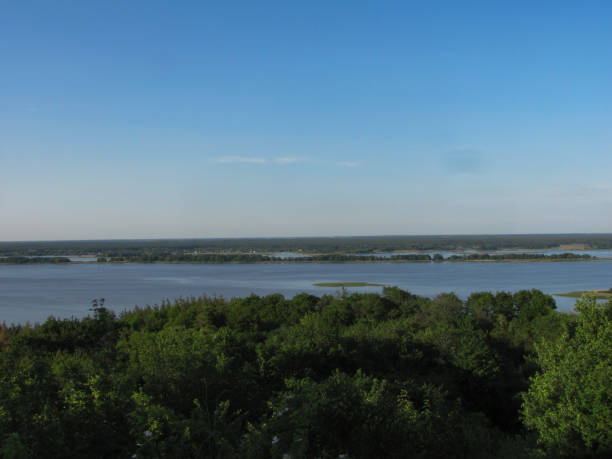 istock landscape background: green forest, river with islands and blue sky 1286894883