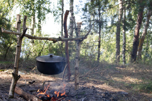 istock Black bowler hat with ear on the fire near the lake 1286896550