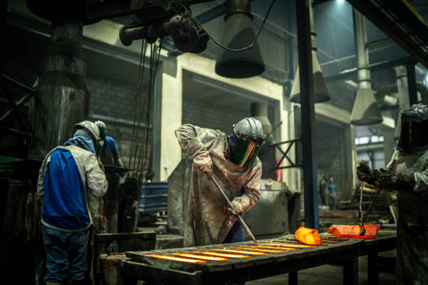 istock Metal industry work - removing hot iron using tweezers 1286897435