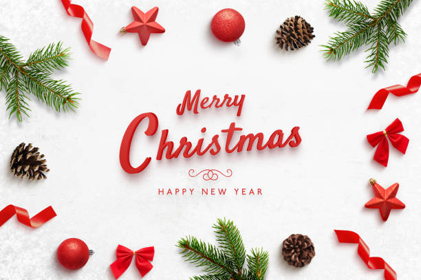 istock Merry Christmas and Happ New Year greeting card with Christmas derorations. Red text surrounded by tree branches, balls, stars, cones, bows. 1286897724