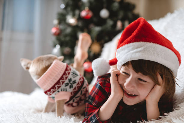 istock Happy Little child and dog at Christmas 1286898511