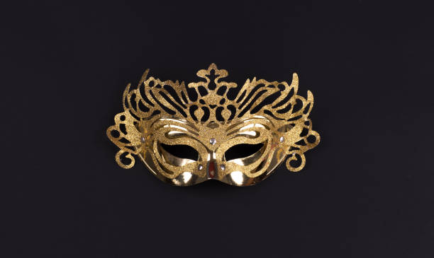 istock golden masquerade mask isolated on black background 1286899572