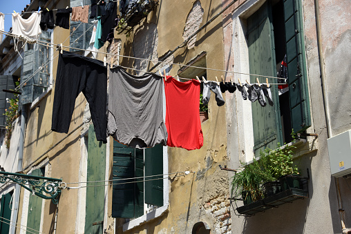 cleaned laundry hanging on a rope as it is (or was) tradition in italy and other southern countries. The image was captured during the worldwide coronavirus panedmic in Venice city.