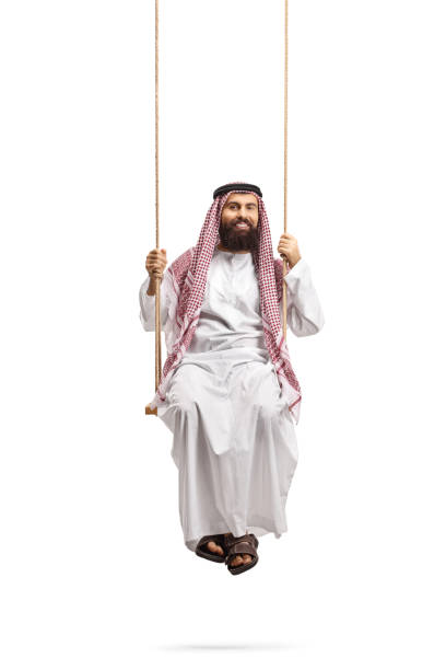istock Saudi arab man in a thobe sitting on a swing 1286900627