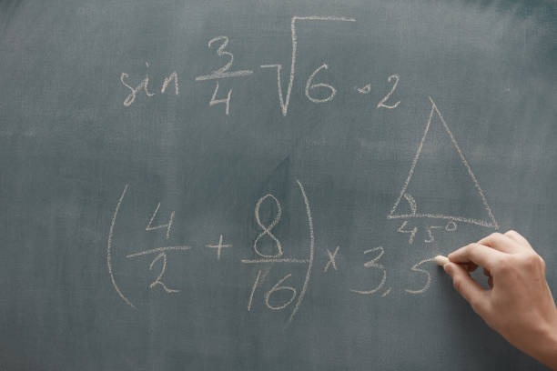 istock Hand of student studying mathematics and writing on a blackbroard 1286903195