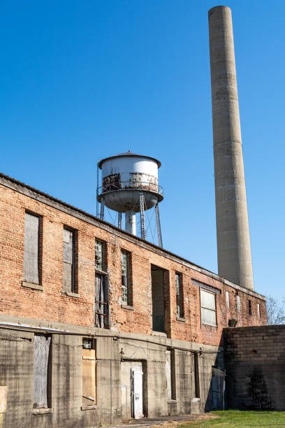 istock Old abandoned smoke stack and water tower in a derelict industrial area.  Amboy, Illinois. 1286904157