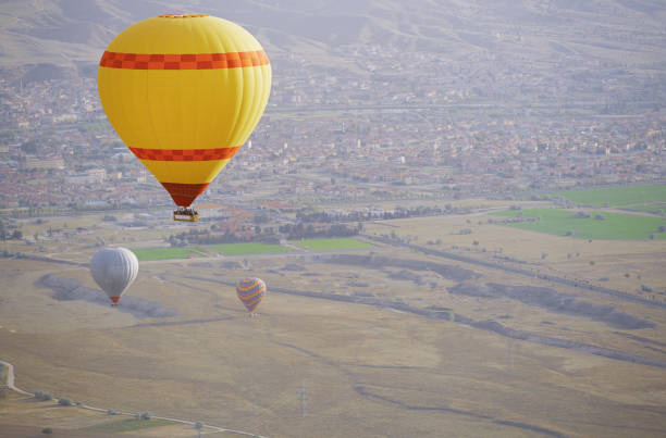 istock Three air balloons flying over the land. Front view 1286904219