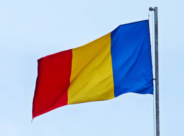 istock Romania flag blowing in the wind with a blue sky in the background. 1286905541