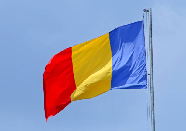 istock Romania flag blowing in the wind with a blue sky in the background. 1286905542